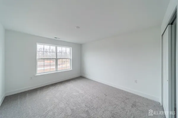 a view of an empty room and closet area
