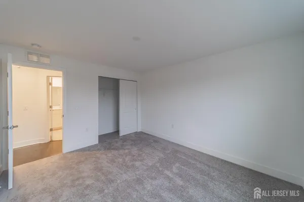 a bathroom with a double vanity sink toilet mirror and bathtub