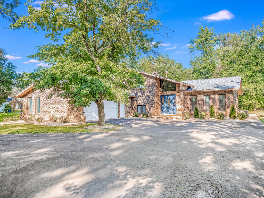 1513 Wood Street Crete, IL 60417 - Photo 1 of 35 a front view of a house with a yard and trees