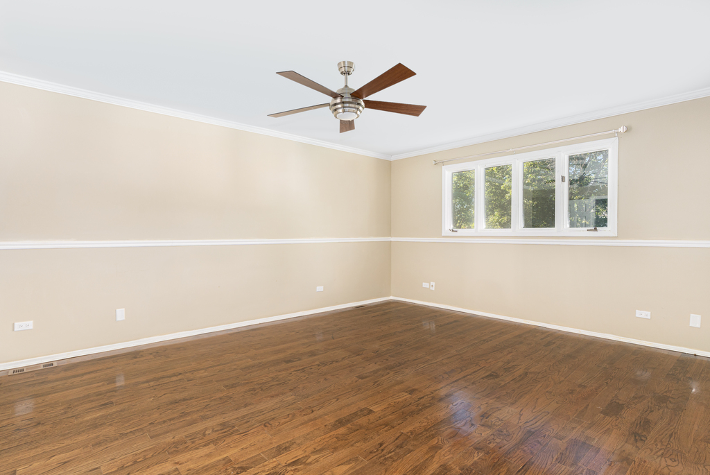 1513 Wood Street Crete, IL 60417 - Photo 11 of 35 an empty room with wooden floor fan and windows