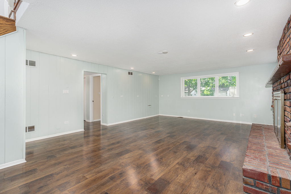 1513 Wood Street Crete, IL 60417 - Photo 16 of 35 a view of an empty room with a window and wooden floor