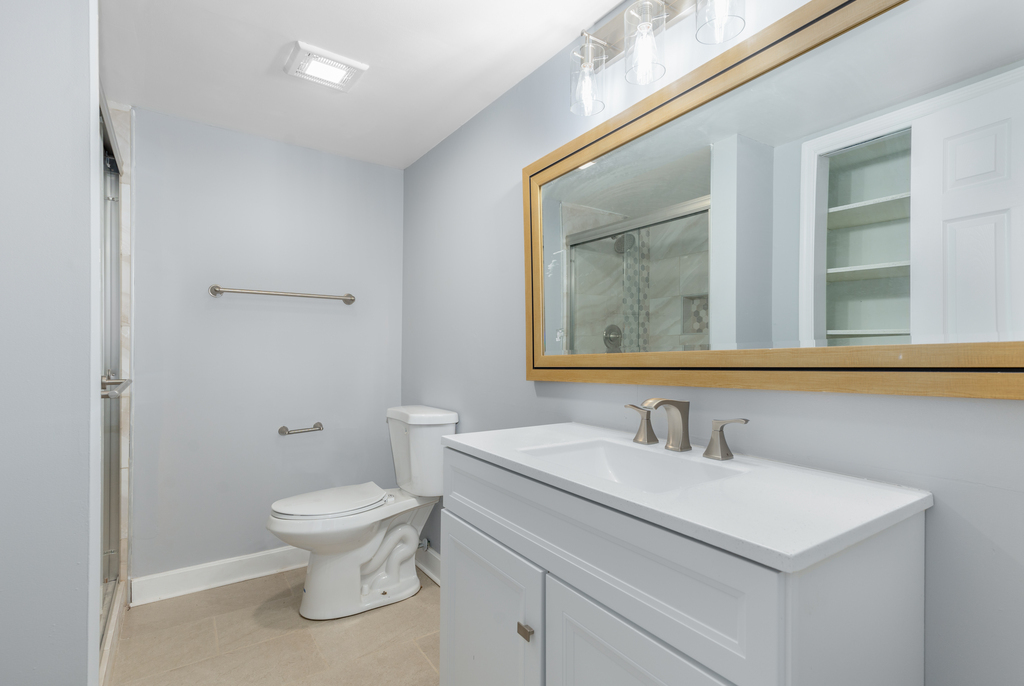 1513 Wood Street Crete, IL 60417 - Photo 18 of 35 a bathroom with a toilet sink and mirror