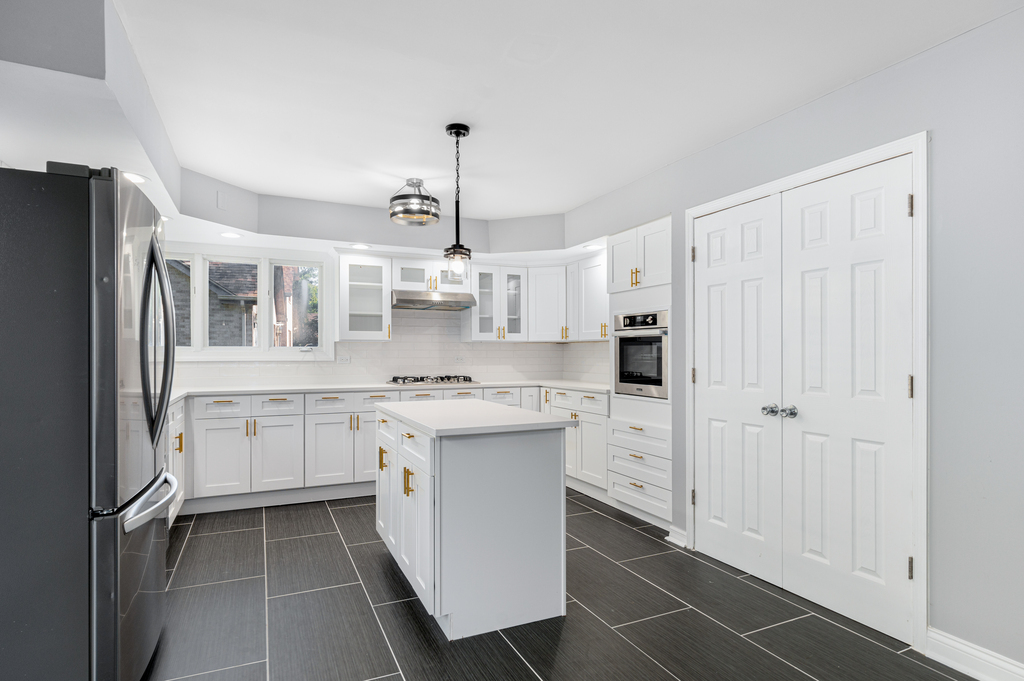 1513 Wood Street Crete, IL 60417 - Photo 6 of 35 a kitchen with white cabinets and white appliances