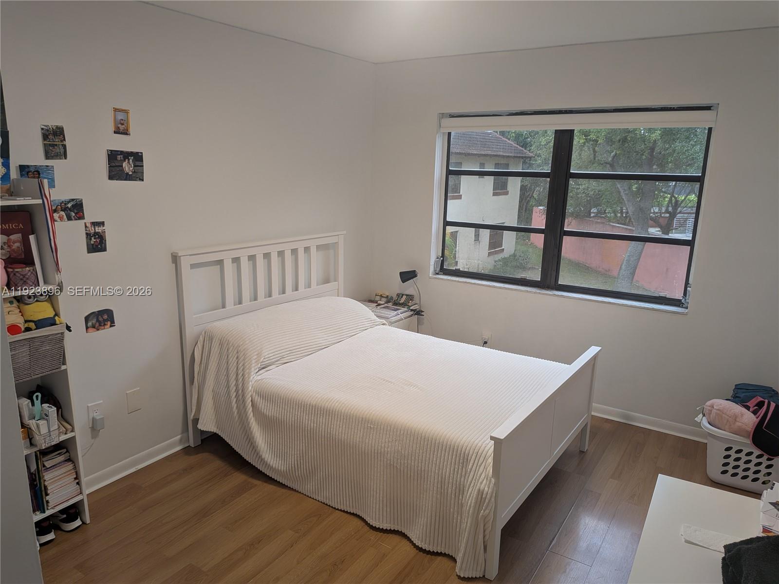 8540 Southwest 149th Avenue, Unit 815 Miami, FL 33193 - Photo 12 of 16 a bed sitting in a bedroom next to a window