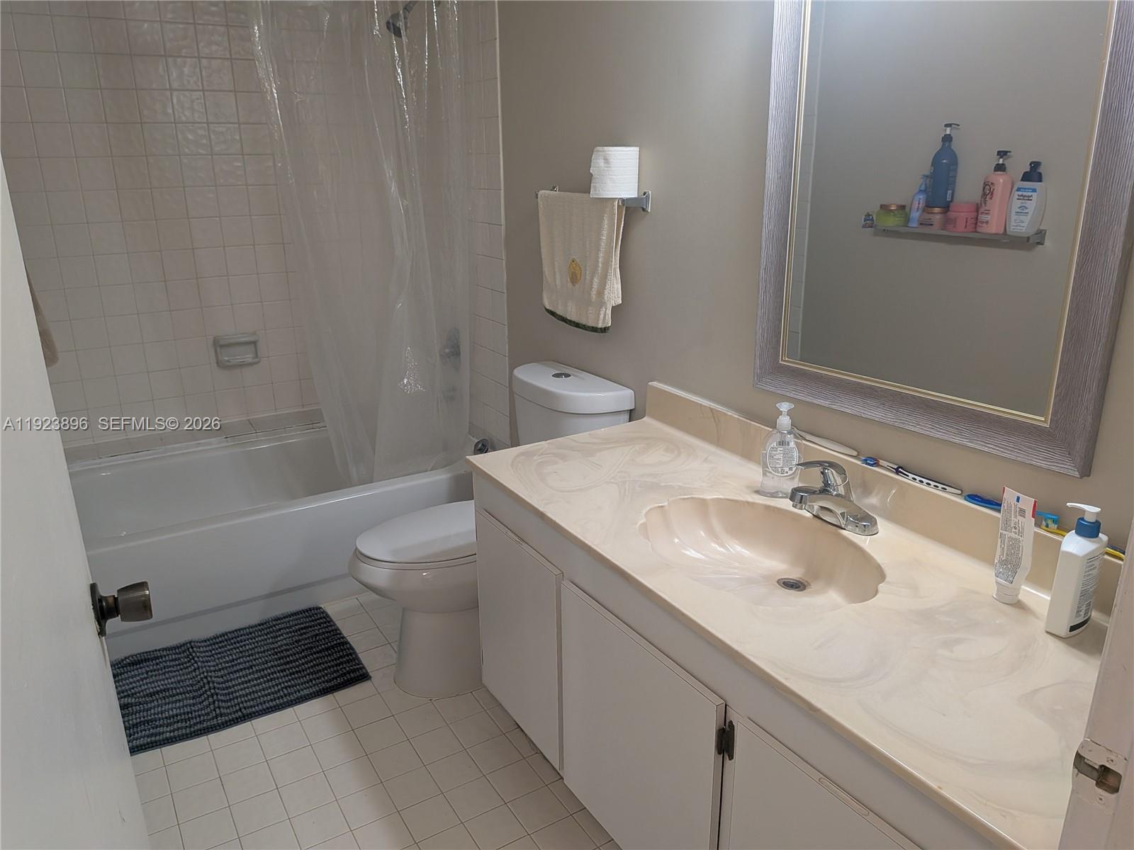 8540 Southwest 149th Avenue, Unit 815 Miami, FL 33193 - Photo 13 of 16 a bathroom with a sink toilet and shower
