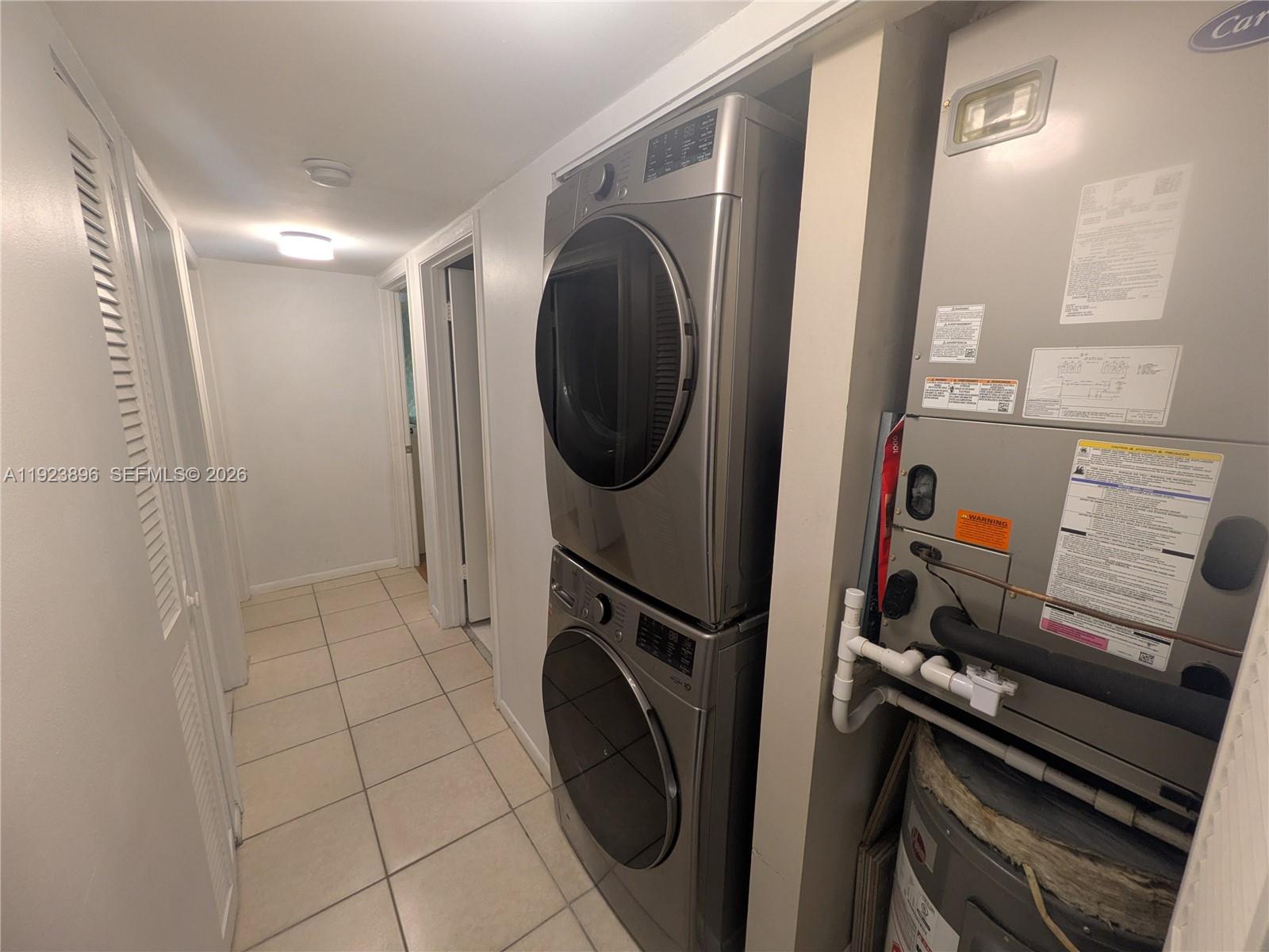 8540 Southwest 149th Avenue, Unit 815 Miami, FL 33193 - Photo 14 of 16 a view of a storage and utility room with washer and dryer