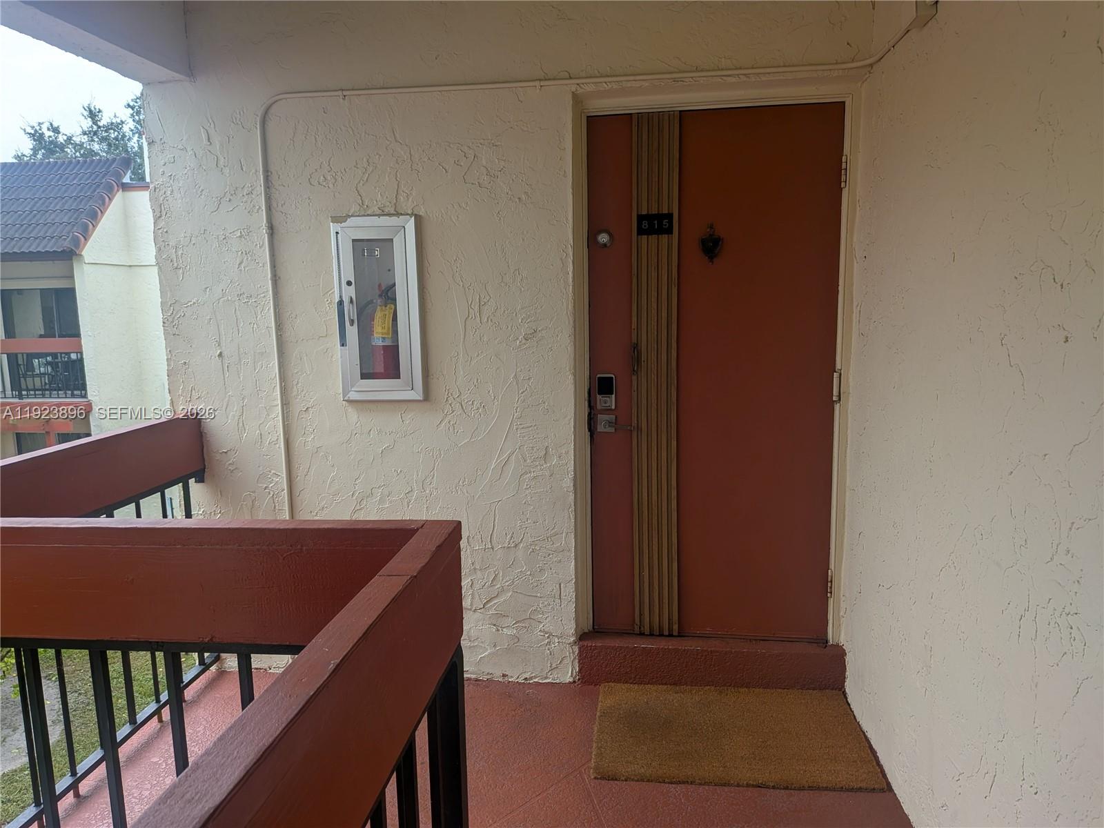 8540 Southwest 149th Avenue, Unit 815 Miami, FL 33193 - Photo 15 of 16 a view of a hallway with wooden floor and a cabinet