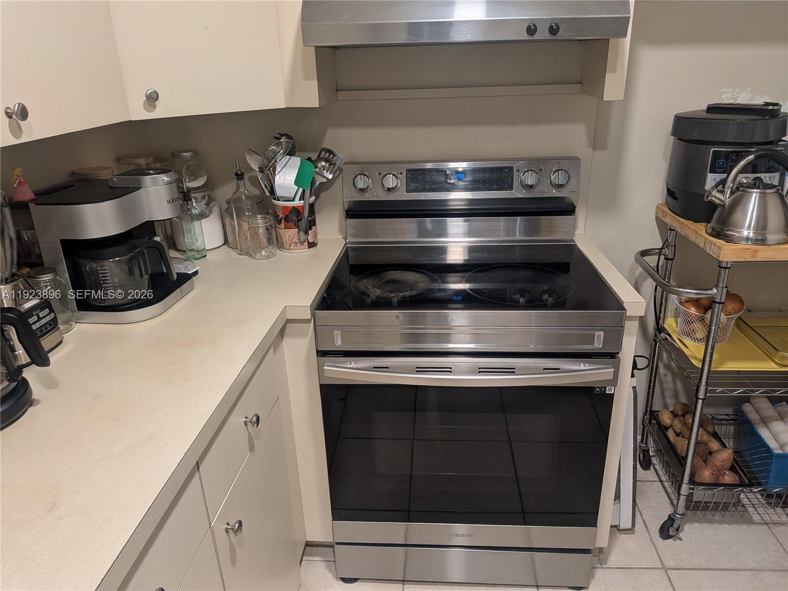 8540 Southwest 149th Avenue, Unit 815 Miami, FL 33193 - Photo 4 of 16 a stove top oven sitting inside of a kitchen