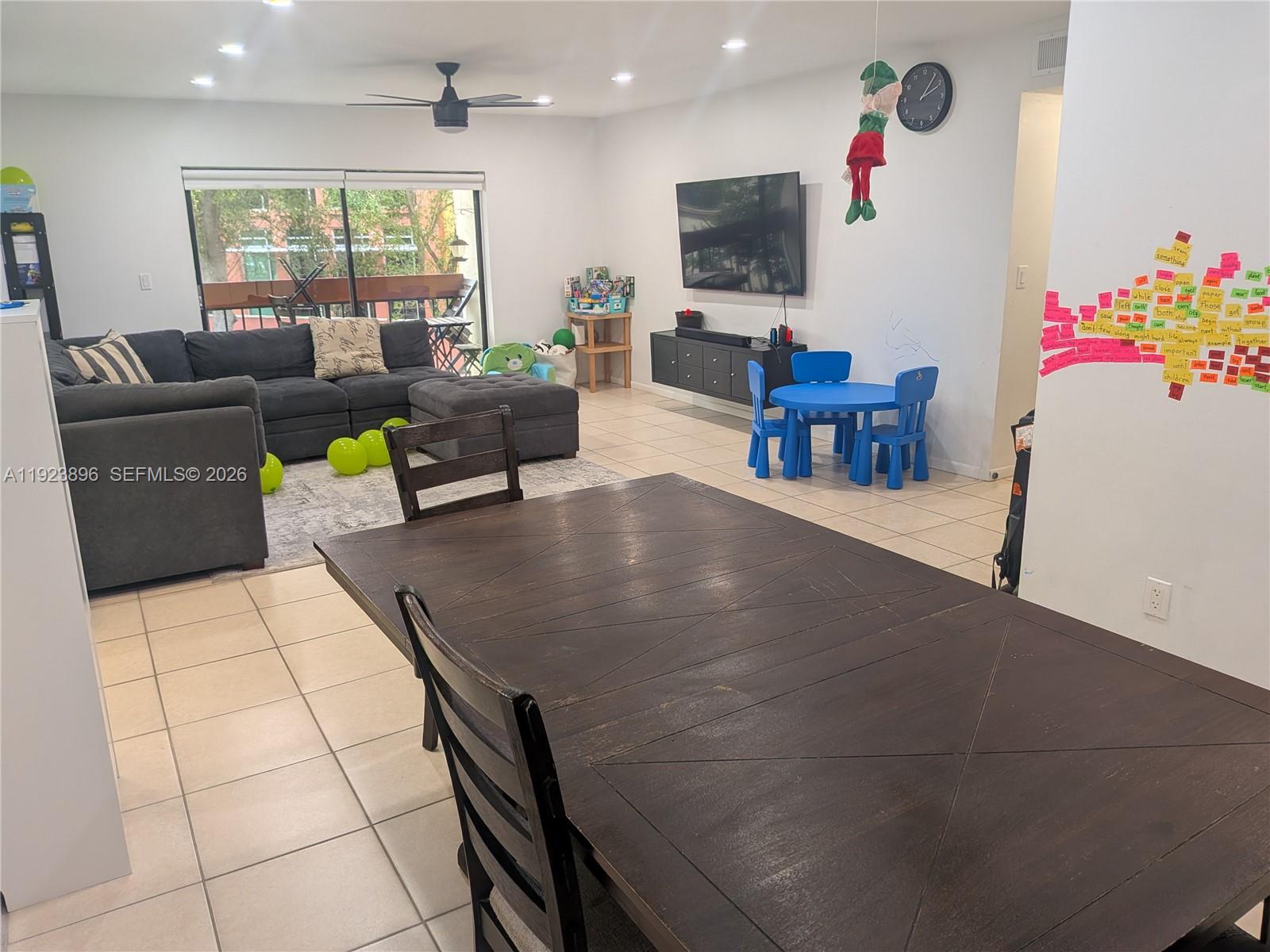 8540 Southwest 149th Avenue, Unit 815 Miami, FL 33193 - Photo 7 of 16 a living room with furniture and a flat screen tv