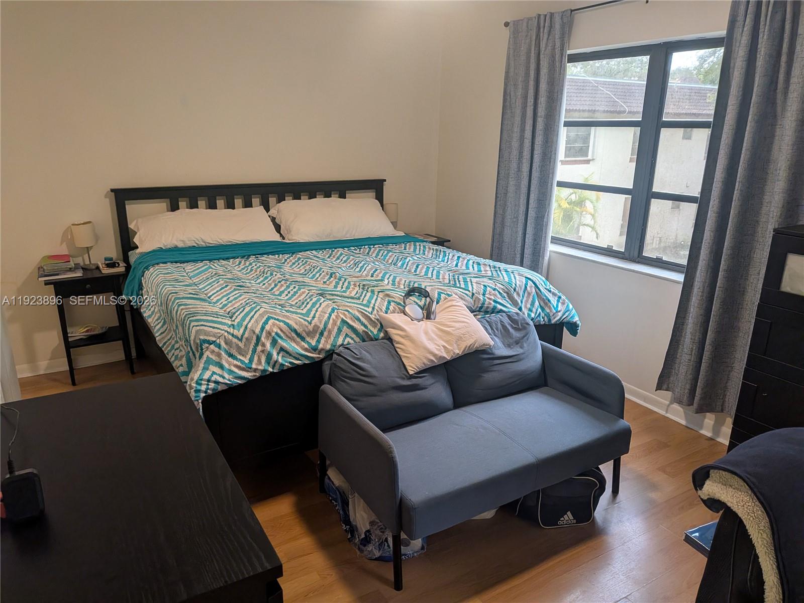 8540 Southwest 149th Avenue, Unit 815 Miami, FL 33193 - Photo 9 of 16 a bed sitting in a bedroom next to a window