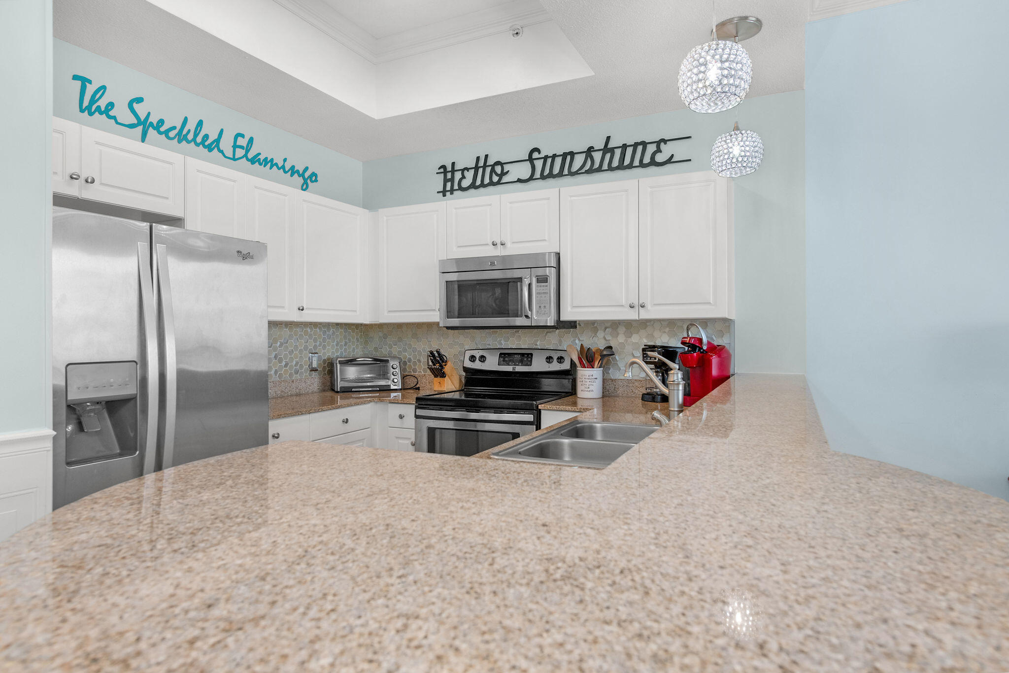 590 Santa Rosa Boulevard, Unit 613 Fort Walton Beach, FL 32548 - Photo 17 of 33 a kitchen with granite countertop a refrigerator and a stove top oven