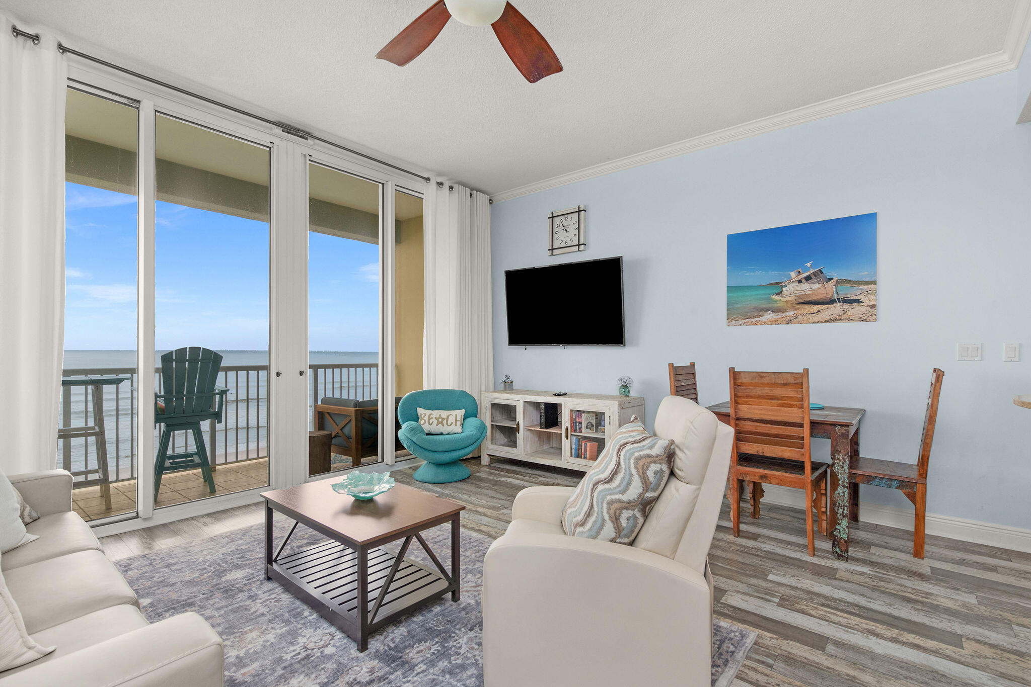 590 Santa Rosa Boulevard, Unit 613 Fort Walton Beach, FL 32548 - Photo 19 of 33 a living room with furniture a flat screen tv and a floor to ceiling window