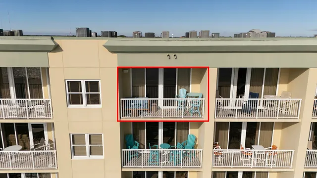 a view of building with a window and wooden fence