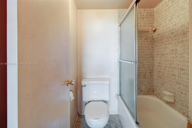 a bathroom with a toilet and a bathtub