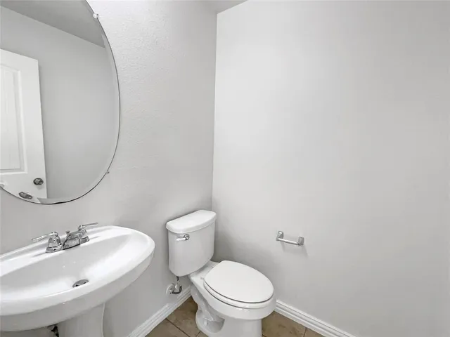 a white toilet sitting next to a bathroom sink