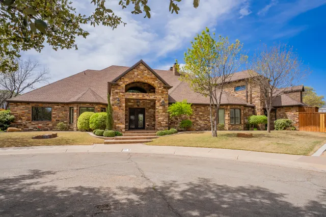 a front view of a house with a yard and a garage