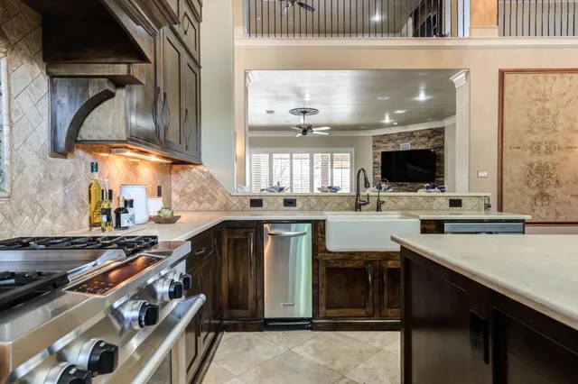 a view of a room with wooden floor chandelier and windows