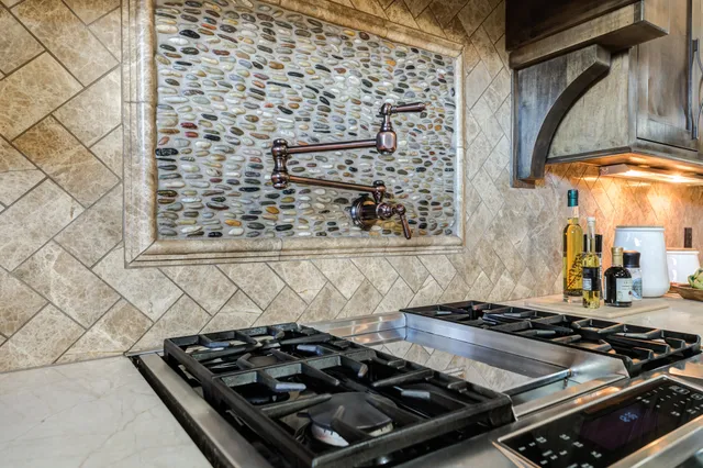 an empty room with wooden floor chandelier fan and windows