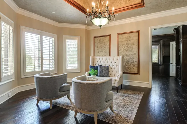 a kitchen with a dining table chairs cabinets and stainless steel appliances
