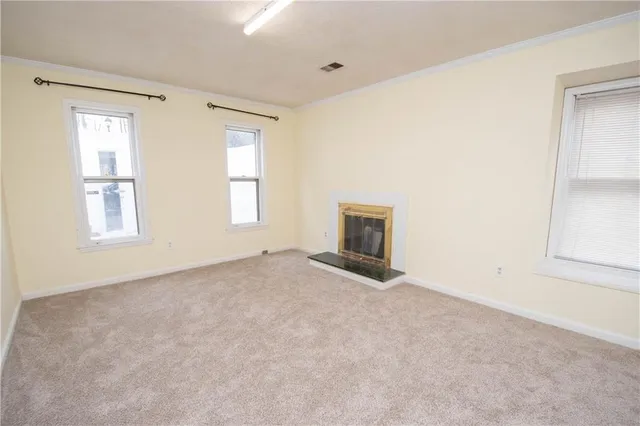 an empty room with wooden floor and window
