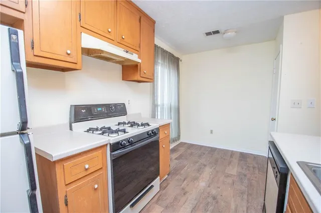 a bathroom with a double vanity sink toilet mirror and shower
