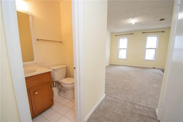 an empty room with a fireplace and wooden floor