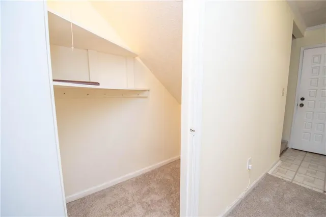 an empty room with a fireplace and a window