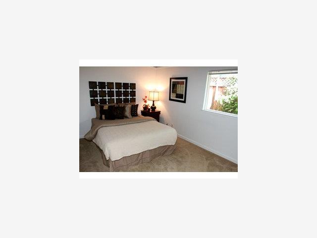 2416 Laura Lane Mountain View, CA 94043 - Photo 6 of 9 a living room with a couch and a table