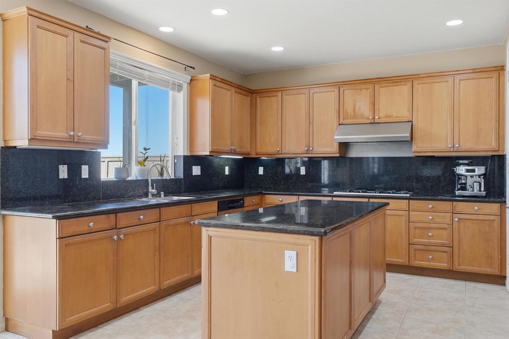 2784 Rambling Vista Road Chula Vista, CA 91915 - Photo 12 of 42 a kitchen with stainless steel appliances granite countertop a sink stove and cabinets