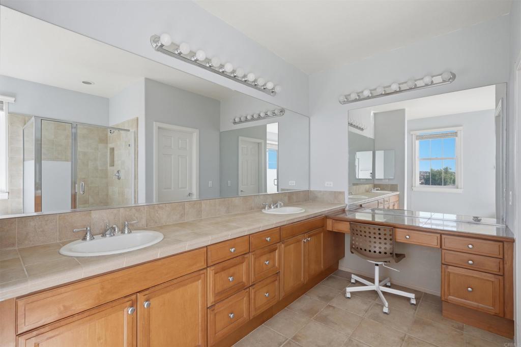 2784 Rambling Vista Road Chula Vista, CA 91915 - Photo 22 of 42 a bathroom with a granite countertop double sink and a mirror