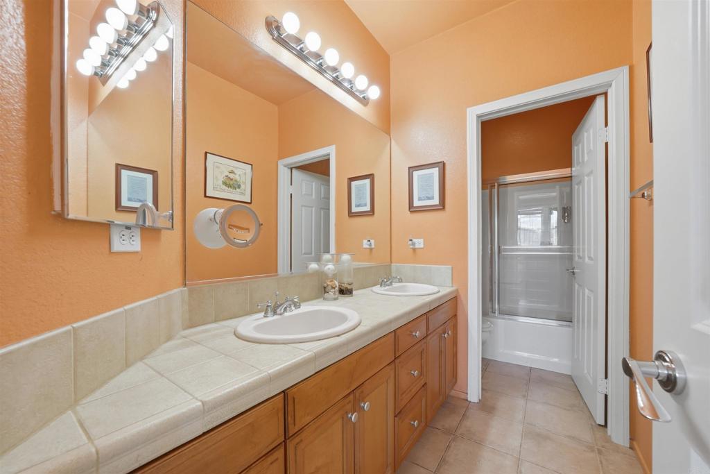 2784 Rambling Vista Road Chula Vista, CA 91915 - Photo 25 of 42 a bathroom with a sink a vanity and a mirror