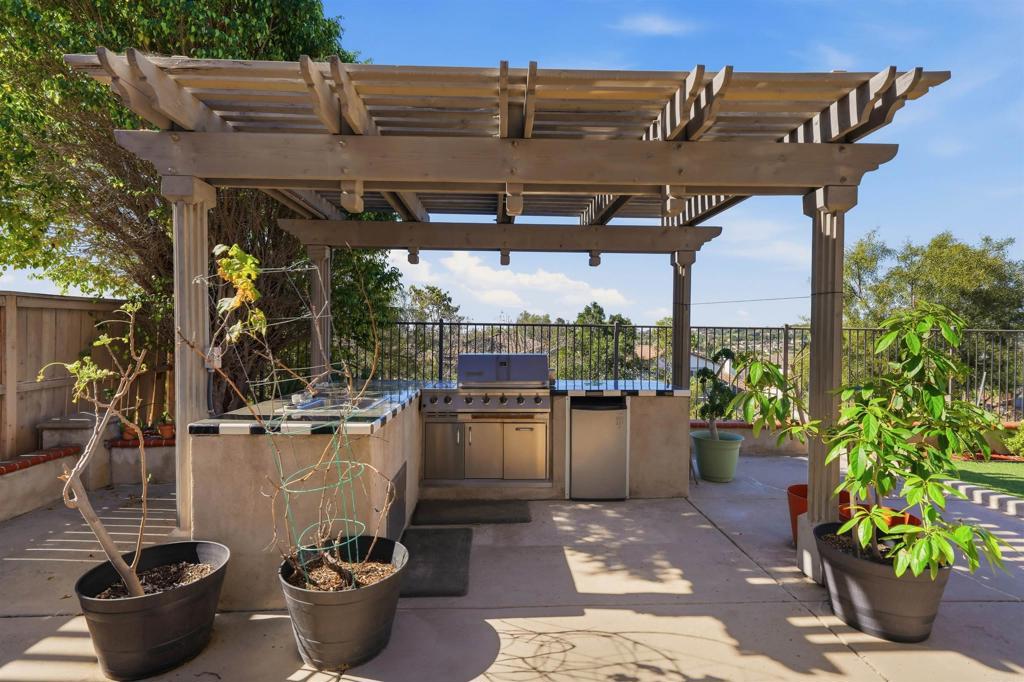 2784 Rambling Vista Road Chula Vista, CA 91915 - Photo 4 of 42 a view of a patio with table and chairs potted plants