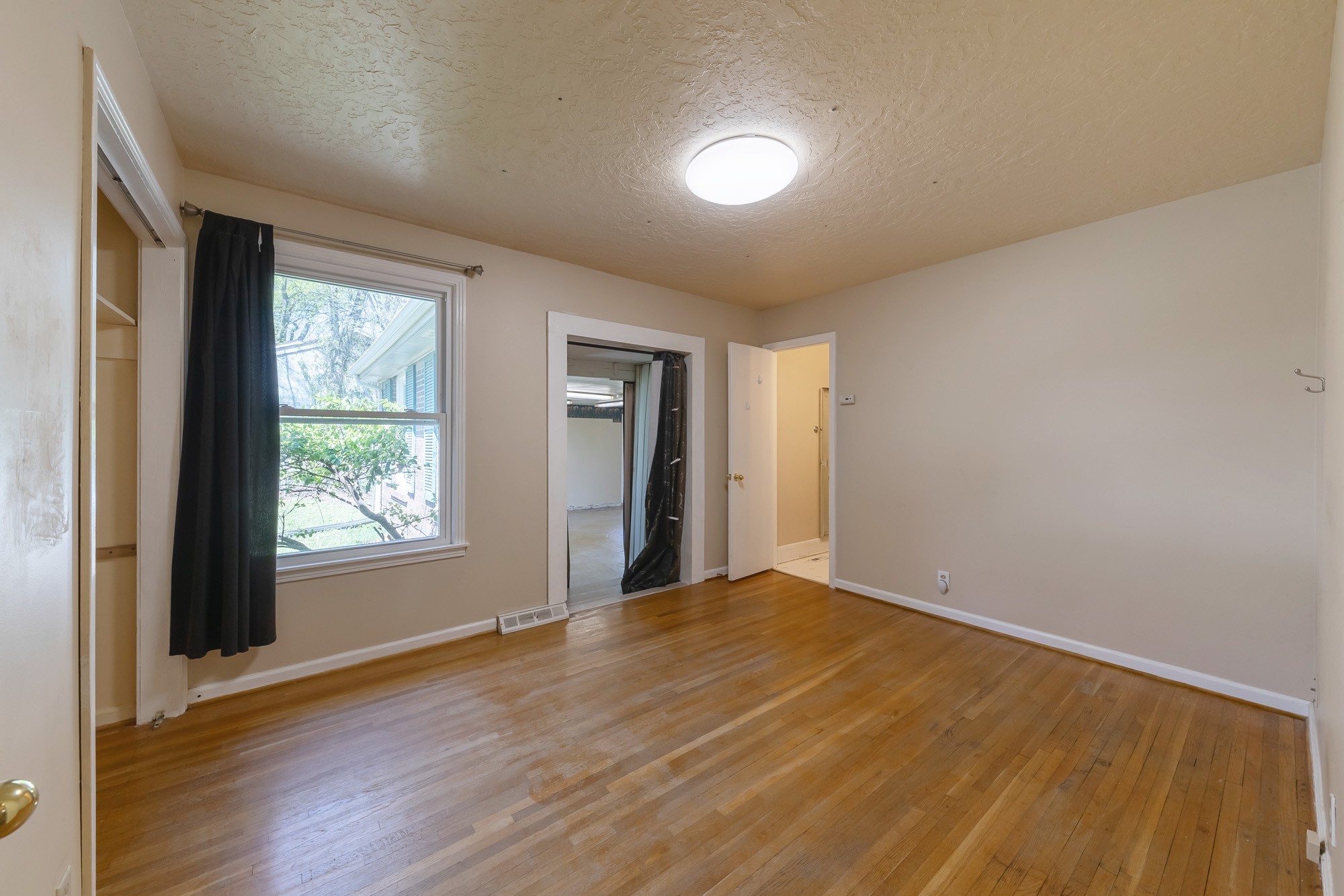 2906 Anderson Road Nashville, TN 37217 - Photo 14 of 35 a view of an empty room with wooden floor and a window