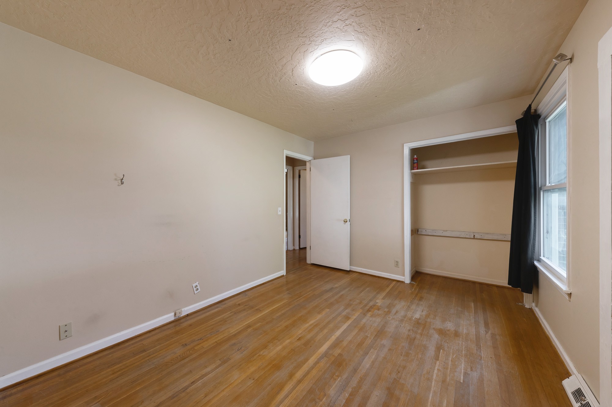 2906 Anderson Road Nashville, TN 37217 - Photo 22 of 35 a view of an empty room with wooden floor and a window