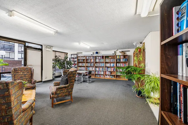 a view of living room with furniture and book shelf
