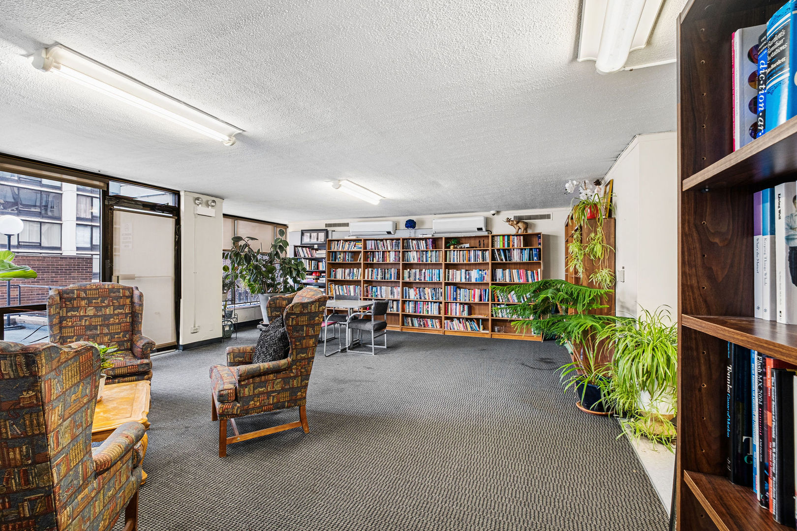 5455 North Sheridan Road, Unit 509 Chicago, IL 60640 - Photo 13 of 19 a view of living room with furniture and book shelf