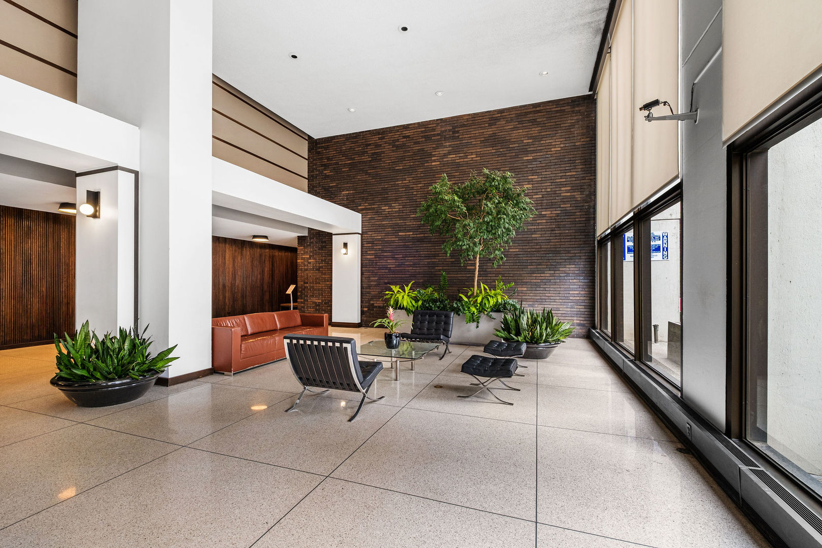 5455 North Sheridan Road, Unit 509 Chicago, IL 60640 - Photo 17 of 19 a lobby with furniture and potted plant