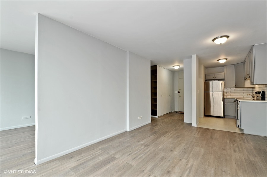 5455 North Sheridan Road, Unit 509 Chicago, IL 60640 - Photo 2 of 19 a view of a kitchen with a refrigerator and a sink