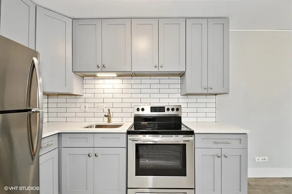 a kitchen with a sink stove and refrigerator