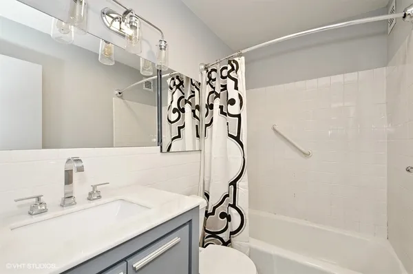 a bathroom with a sink a mirror and a shower