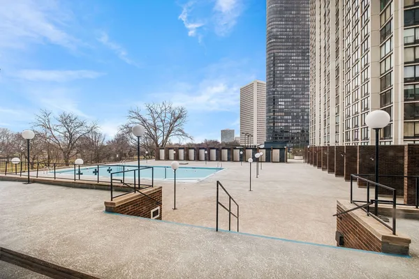 a view of swimming pool with outdoor seating and city view