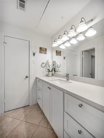a spacious bathroom with a double vanity sink mirror and