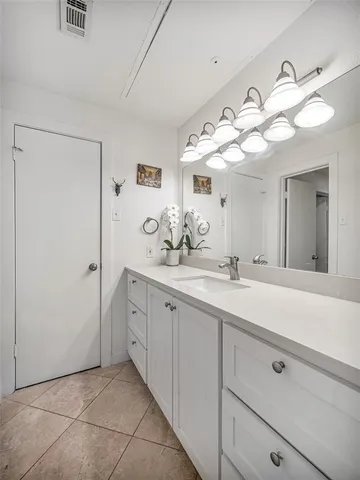 a spacious bathroom with a double vanity sink mirror and