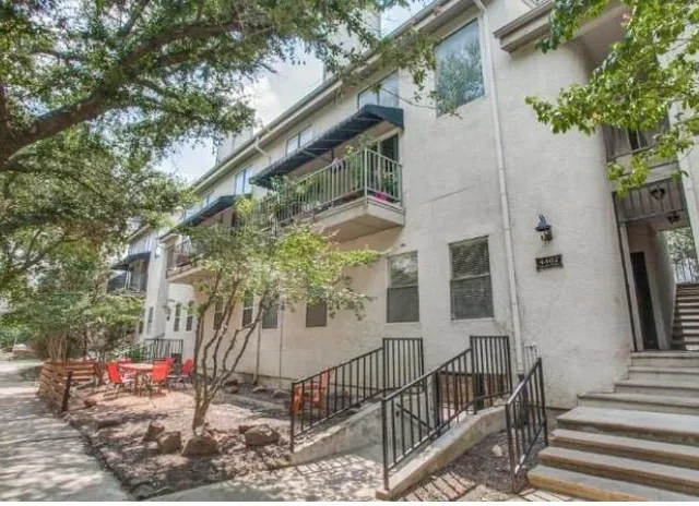 a view of patio with table and chairs and potted plants