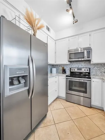 a kitchen with stainless steel appliances cabinets a sink and a counter top space