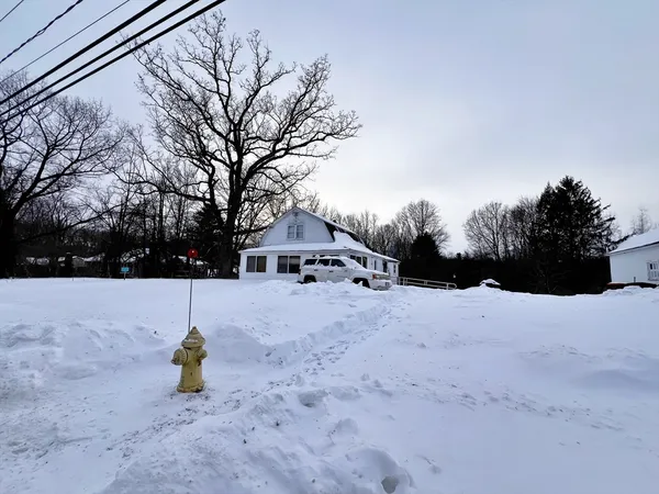 a view of a house with a snow in the yard