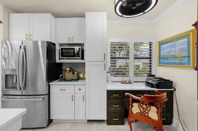 a kitchen with stainless steel appliances granite countertop a refrigerator and a sink