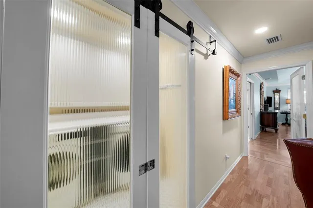 a view of hallway with wooden floor