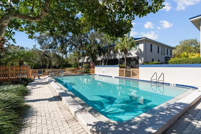 an aerial view of a city with lots of residential buildings ocean and mountain view in back