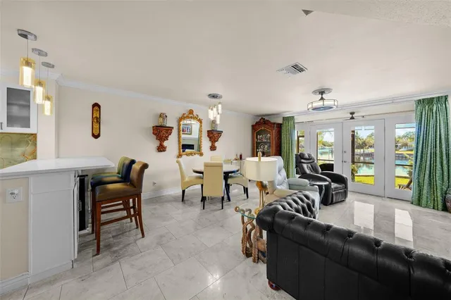 a living room with furniture and large windows